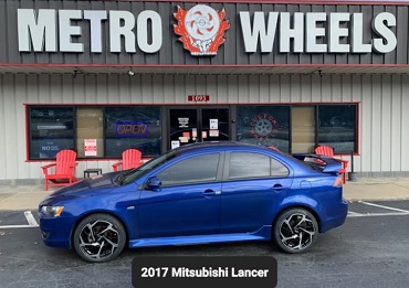 Sport Tuning STI 18 inch wheels installed on a blue 2017 Mitsubishi Lancer in Marietta, GA at Metro Wheels & Accessories